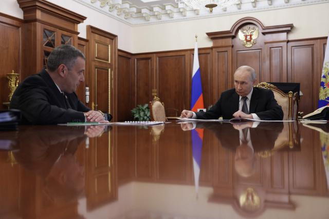 In this pool photograph distributed by the Russian state agency Sputnik, Russia's President Vladimir Putin meets with the Kursk region governor Alexander Khinshtein in Moscow on June 30, 2026. (Photo by Gavriil Grigorov / POOL / AFP)