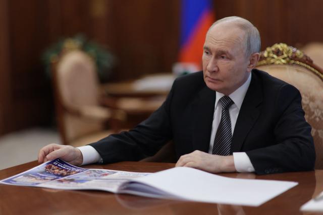 In this pool photograph distributed by the Russian state agency Sputnik, Russia's President Vladimir Putin meets with the Kursk region governor in Moscow on June 30, 2026. (Photo by Gavriil Grigorov / POOL / AFP)