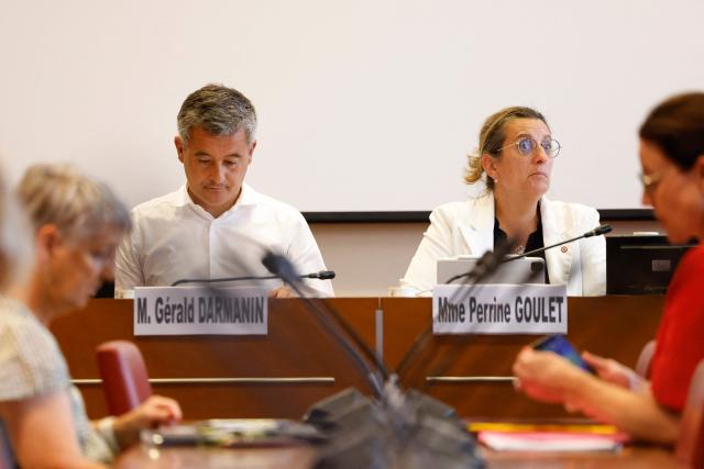 France's Justice Minister Gerald Darmanin (L) and Les Democrates' MP Perrine Goulet (R) attend a hearing before the National Assembly's special committee on a bill on the protection of children, in Paris on June 30, 2026. (Photo by Kenzo TRIBOUILLARD / AFP)