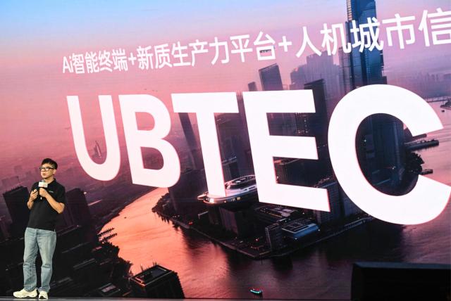 Zhou Jian, also known as James Zhou and founder of UBTECH Robotics delivers his speech during the launch of the U1 humanoid robot produced by UWORLD, a brand under UBTECH Robotics, in Shenzhen, China's Guangdong province on June 30, 2026. Silicone skin, soothing voice: Chinese company UBTech unveiled unprecedented hyper-realistic human-looking androids equipped with artificial intelligence (AI) and presented as anti-loneliness remedies. (Photo by ADEK BERRY / AFP)