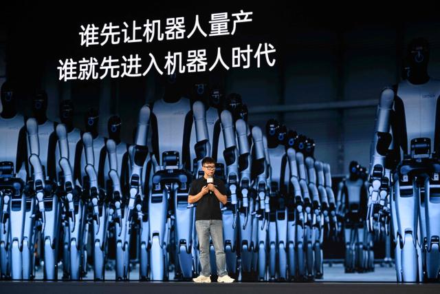 Zhou Jian, also known as James Zhou and founder of UBTECH Robotics delivers his speech during the launch of the U1 humanoid robot produced by UWORLD, a brand under UBTECH Robotics, in Shenzhen, China's Guangdong province on June 30, 2026. Silicone skin, soothing voice: Chinese company UBTech unveiled unprecedented hyper-realistic human-looking androids equipped with artificial intelligence (AI) and presented as anti-loneliness remedies. (Photo by ADEK BERRY / AFP)