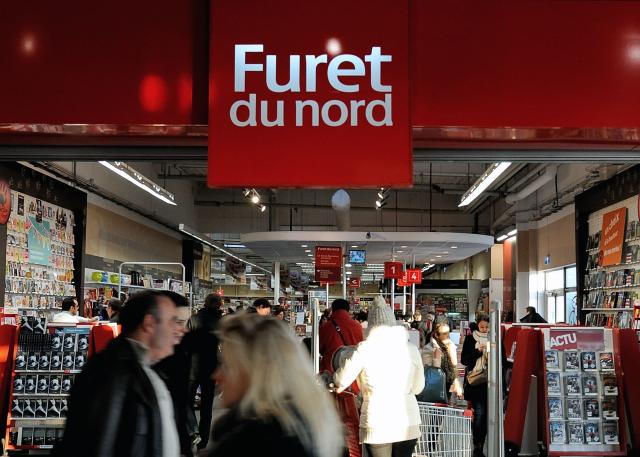 (FILES) People walk by a "Furet du Nord" entertainment retailer store on January 16, 2013 in a mall in Englos, Northern France. The struggling Nosoli Group, which owns the Furet du Nord and Decitre bookstore chains, announced on June 30, 2026 that it plans to close 11 of the 27 stores operated by these two chains and cut up to 163 jobs. (Photo by PHILIPPE HUGUEN / AFP)
