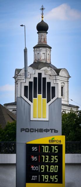 A scoreboard of a Rosneft gas station shows fuel prices in Moscow on June 30, 2026, with a church seen in the background. Russia's largest oil giants are tightening fuel restrictions at their gas stations in Moscow and the Moscow region as the fuel crisis, engulfed virtually every region, deepens after the Kapotnya refinery in Moscow burned twice in June as a result of Ukrainian drone strikes, as well as few more refineries in Russia, and now dispensing no more than 20 liters of gasoline per vehicle. Filling canisters is prohibited, local media report. (Photo by Alexander NEMENOV / AFP)