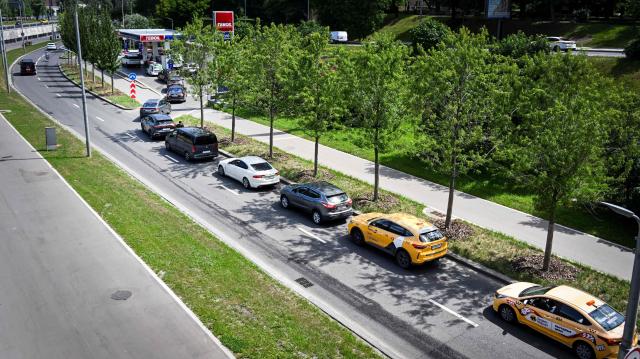 People queue to refuel their cars at a Teboil gas station in Moscow on June 30, 2026. Russia's largest oil giants are tightening fuel restrictions at their gas stations in Moscow and the Moscow region as the fuel crisis, engulfed virtually every region, deepens after the Kapotnya refinery in Moscow burned twice in June as a result of Ukrainian drone strikes, as well as few more refineries in Russia, and now dispensing no more than 20 liters of gasoline per vehicle. Filling canisters is prohibited, local media report. (Photo by Alexander NEMENOV / AFP)