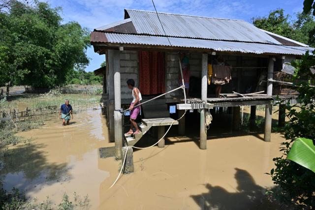 A villager wades through floodwaters in Dhemaji on June 30, 2026. (Photo by Biju BORO / AFP)
