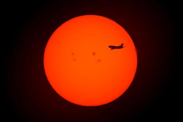 An aircraft flies at sunrise in Buenos Aires on June 30, 2026. (Photo by Luis ROBAYO / AFP)