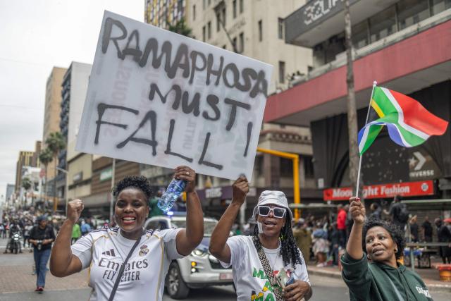 Protesters hold a placard as they chant slogans during a demonstration by the "March and March" movement marking an unofficial deadline set by citizen-led groups for undocumented foreign nationals to leave South Africa, in Durban, on June 30, 2026. Thousands of demonstrators massed across South African cities on June 30, 2026, venting anger at undocumented foreign nationals as police mounted a major operation to head off looting and xenophobic violence that has claimed four lives. 
The nationwide protests cap weeks of demonstrations called by a loose coalition of minor political parties and small citizen-led vigilante groups, which set an unofficial June 30 deadline for foreigners without residency papers to leave. (Photo by RAJESH JANTILAL / AFP)