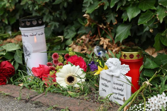 Flowers and candles are left at a makeshift memorial at the scene where six people were killed in a shooting the day before in Stade, northern Germany, a city some 50 kilometres west of Hamburg, on June 30, 2026. The suspected shooter who killed six people at a German youth welfare centre on Monday was in a custody dispute over his three-month-old daughter, police said. The victims of the shooting -- four women and two men -- were youth welfare employees, a police official told a press conference. The girl and her mother were in the office at the time of the shooting but were not harmed. (Photo by Ibrahim OT / AFP)