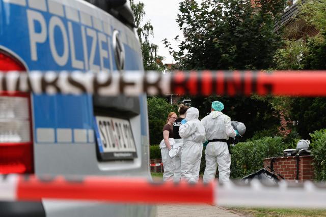 Forensic Police officers work at the scene where six people were killed in a shooting the day before in Stade, northern Germany, a city some 50 kilometres west of Hamburg, on June 30, 2026. The suspected shooter who killed six people at a German youth welfare centre on Monday was in a custody dispute over his three-month-old daughter, police said. The victims of the shooting -- four women and two men -- were youth welfare employees, a police official told a press conference. The girl and her mother were in the office at the time of the shooting but were not harmed. (Photo by Ibrahim OT / AFP)
