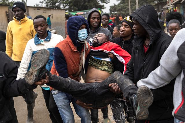 EDITORS NOTE: Graphic content / Protesters carry the body of a man as they march towards a local police station after he was shot dead by police during demonstrations against alleged police abductions in the Mathare informal settlement of Nairobi on June 30, 2026. Running battles erupted between locals and police in a Nairobi informal settlement on June 30, 2026 leaving one person dead and two wounded, AFP journalists saw, after the alleged abduction of two activists by security forces.
Protests broke out in the Mathare informal settlement after planned demonstrations last week were prevented by a huge police deployment, which saw some activists detained and disappeared for days. (Photo by Tony KARUMBA / AFP)