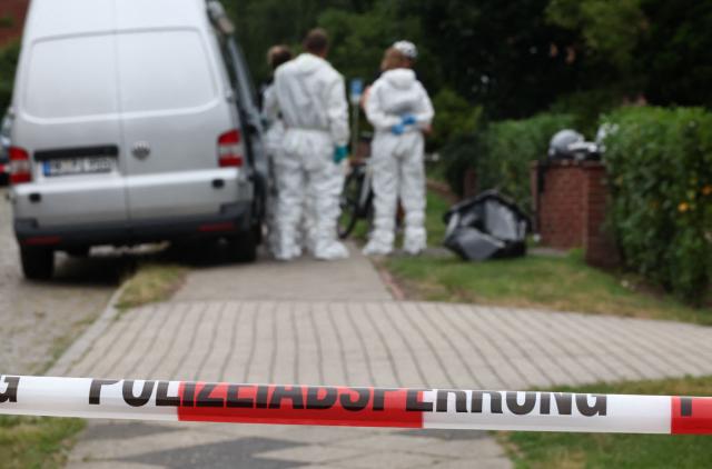 Police forensics work behind the police cordon at the scene where six people were killed in a shooting the day before in Stade, northern Germany, a city some 50 kilometres west of Hamburg, on June 30, 2026. The suspected shooter who killed six people at a German youth welfare centre on Monday was in a custody dispute over his three-month-old daughter, police said. The victims of the shooting -- four women and two men -- were youth welfare employees, a police official told a press conference. The girl and her mother were in the office at the time of the shooting but were not harmed. (Photo by Ibrahim OT / AFP)