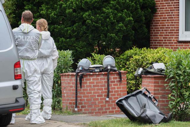Forensic Police officers leave their breathing apparatus on a wall as they work at the scene where six people were killed in a shooting the day before in Stade, northern Germany, a city some 50 kilometres west of Hamburg, on June 30, 2026. The suspected shooter who killed six people at a German youth welfare centre on Monday was in a custody dispute over his three-month-old daughter, police said. The victims of the shooting -- four women and two men -- were youth welfare employees, a police official told a press conference. The girl and her mother were in the office at the time of the shooting but were not harmed. (Photo by Ibrahim OT / AFP)