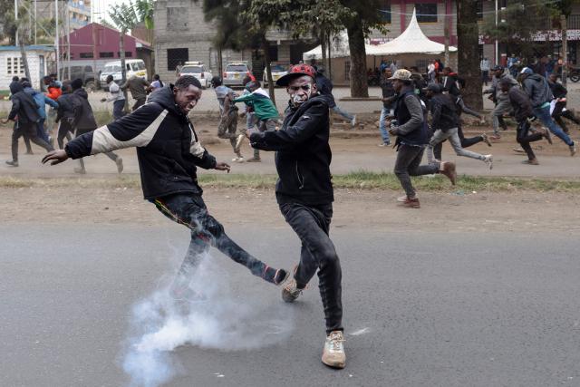 EDITORS NOTE: Graphic content / Protesters kick a tear gas canister as they clash with Kenyan police during a protest against alleged police abductions in the Mathare informal settlement of Nairobi on June 30, 2026. Running battles erupted between locals and police in a Nairobi informal settlement on June 30, 2026 leaving one person dead and two wounded, AFP journalists saw, after the alleged abduction of two activists by security forces.
Protests broke out in the Mathare informal settlement after planned demonstrations last week were prevented by a huge police deployment, which saw some activists detained and disappeared for days. (Photo by Tony KARUMBA / AFP)