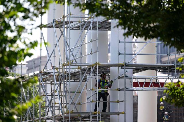 Workers build scaffolding around the columns of the North Portico of the White House in Washington, DC, on June 30, 2026. (Photo by Kent Nishimura / AFP)