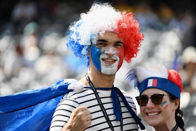 French fans with painted faces pose for a photo ahead of the 2026 World Cup round of 32 football match between France and Sweden at the New York/New Jersey Stadium in East Rutherford on June 30, 2026.  (Photo by Jewel SAMAD / AFP)