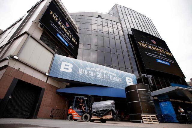A worker drives a forklift outside Madison Square Garden in New York on June 30, 2026. Increasing signs point to a mega-bash for the A-list celebrity couple Taylor Swift and Travis Kelce at Madison Square Garden this week. Rumors have run rampant for weeks that the 36-year-old pop superstar and the three-time NFL Super Bowl winner, both 36, could wed at the storied sports arena, home to the New York Knicks, the newly crowned NBA champions. (Photo by Leonardo MUNOZ / AFP)