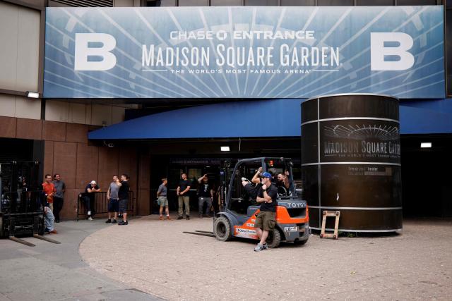 Workers and forklifts are seen outside Madison Square Garden in New York on June 30, 2026. Increasing signs point to a mega-bash for the A-list celebrity couple Taylor Swift and Travis Kelce at Madison Square Garden this week. Rumors have run rampant for weeks that the 36-year-old pop superstar and the three-time NFL Super Bowl winner, both 36, could wed at the storied sports arena, home to the New York Knicks, the newly crowned NBA champions. (Photo by Leonardo MUNOZ / AFP)