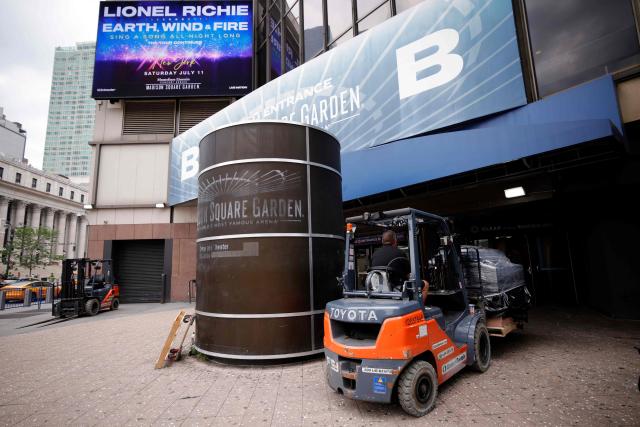 Workers and forklifts are seen outside Madison Square Garden in New York on June 30, 2026. Increasing signs point to a mega-bash for the A-list celebrity couple Taylor Swift and Travis Kelce at Madison Square Garden this week. Rumors have run rampant for weeks that the 36-year-old pop superstar and the three-time NFL Super Bowl winner, both 36, could wed at the storied sports arena, home to the New York Knicks, the newly crowned NBA champions. (Photo by Leonardo MUNOZ / AFP)
