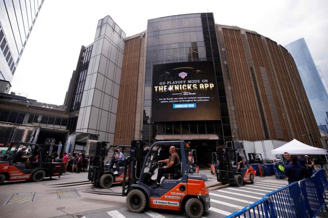 Forklifts and trucks are seen outside Madison Square Garden in New York on June 30, 2026. Increasing signs point to a mega-bash for the A-list celebrity couple Taylor Swift and Travis Kelce at Madison Square Garden this week. Rumors have run rampant for weeks that the 36-year-old pop superstar and the three-time NFL Super Bowl winner, both 36, could wed at the storied sports arena, home to the New York Knicks, the newly crowned NBA champions. (Photo by Leonardo MUNOZ / AFP)