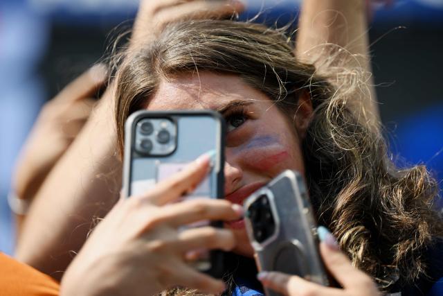 A French fan takes a photo with a cellphone ahead of the 2026 World Cup round of 32 football match between France and Sweden at the New York/New Jersey Stadium in East Rutherford on June 30, 2026.  (Photo by Jewel SAMAD / AFP)
