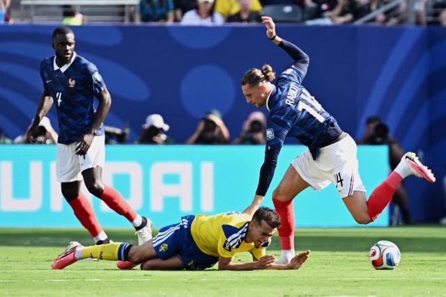 Sweden's midfielder #18 Yasin Ayari falls on the ground past France's midfielder #14 Adrien Rabiot during the 2026 World Cup round of 32 football match between France and Sweden at the New York/New Jersey Stadium in East Rutherford on June 30, 2026.  (Photo by Jewel SAMAD / AFP)