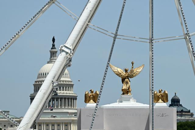 Part of the Ferris wheel is seen with the US Capitol dome in the distance during the "Great American State Fair" on the National Mall in Washington, DC, on June 30, 2026. "The Great American State Fair" is an exhibition of US traditions, its people and culture to celebrate the 250th anniversary of the United States' Declaration of Independence. (Photo by Alex WROBLEWSKI / AFP)