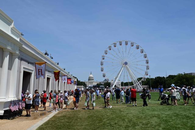 People attend the "Great American State Fair" on the National Mall in Washington, DC, on June 30, 2026. "The Great American State Fair" is an exhibition of US traditions, its people and culture to celebrate the 250th anniversary of the United States' Declaration of Independence. (Photo by Alex WROBLEWSKI / AFP)