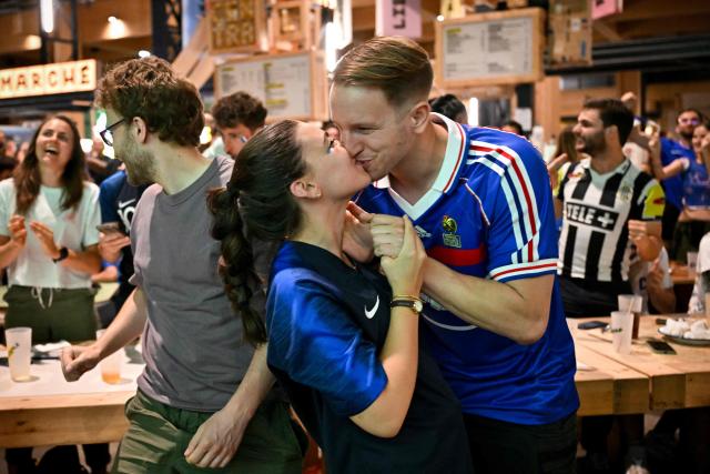 France supporters celebrate France's first goal as they watch the 2026 World Cup round of 32 football match between France and Sweden on a giant screen at 'La Communale de Saint-Ouen', in Saint-Ouen, north of Paris, on June 30, 2026. (Photo by Julie SEBADELHA / AFP)