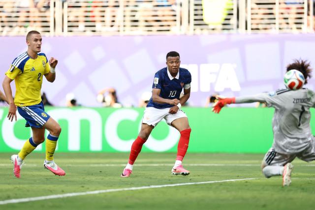 France's forward #10 Kylian Mbappe scores his team's third goal past Sweden's goalkeeper #01 Jacob Widell Zetterstrom during the 2026 World Cup round of 32 football match between France and Sweden at the New York/New Jersey Stadium in East Rutherford on June 30, 2026.  (Photo by CHARLY TRIBALLEAU / AFP)