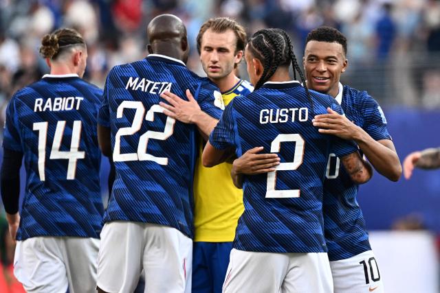 France's forward #10 Kylian Mbappe celebrates with defender #02 Malo Gusto after winning the 2026 World Cup round of 32 football match between France and Sweden at the New York/New Jersey Stadium in East Rutherford on June 30, 2026.  (Photo by Jewel SAMAD / AFP)