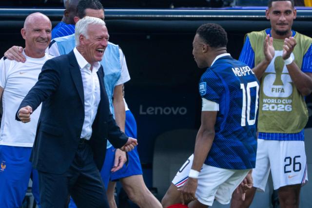 France's head coach Didier Deschamps celebrates with France's forward #10 Kylian Mbappe after he scored his team's first goal during the 2026 World Cup round of 32 football match between France and Sweden at the New York/New Jersey Stadium in East Rutherford on June 30, 2026.  (Photo by Pedro UGARTE / AFP)