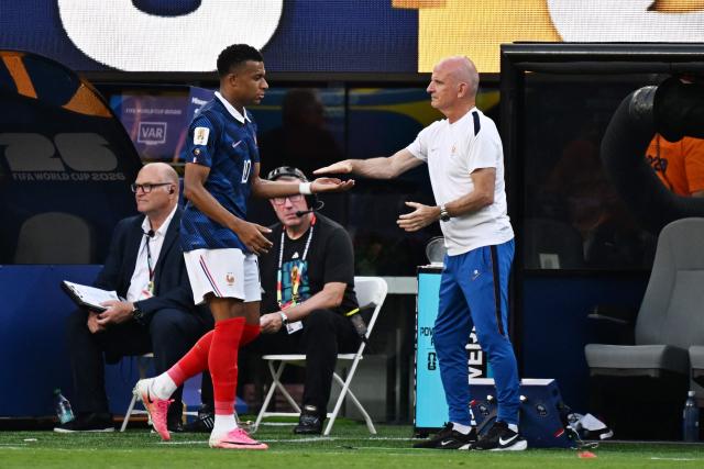 France's forward #10 Kylian Mbappe greets assistant coach Guy Stephan as he leaves the pitch after being substituted during the 2026 World Cup round of 32 football match between France and Sweden at the New York/New Jersey Stadium in East Rutherford on June 30, 2026.  (Photo by Jewel SAMAD / AFP)