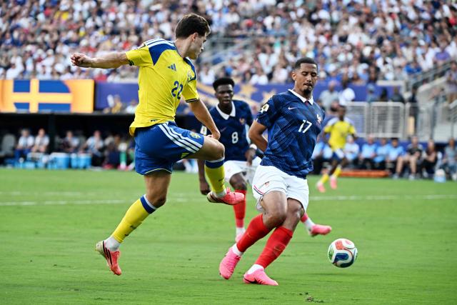 Sweden's midfielder #22 Besfort Zeneli kicks the ball past France's defender #17 William Saliba during the 2026 World Cup round of 32 football match between France and Sweden at the New York/New Jersey Stadium in East Rutherford on June 30, 2026.  (Photo by Jewel SAMAD / AFP)