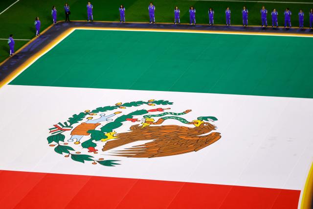 Volunteers display a Mexican flag ahead of the 2026 World Cup round of 32 football match between Mexico and Ecuador at the Mexico City Stadium in Mexico City on June 30, 2026.  (Photo by Rodrigo Oropeza / AFP)