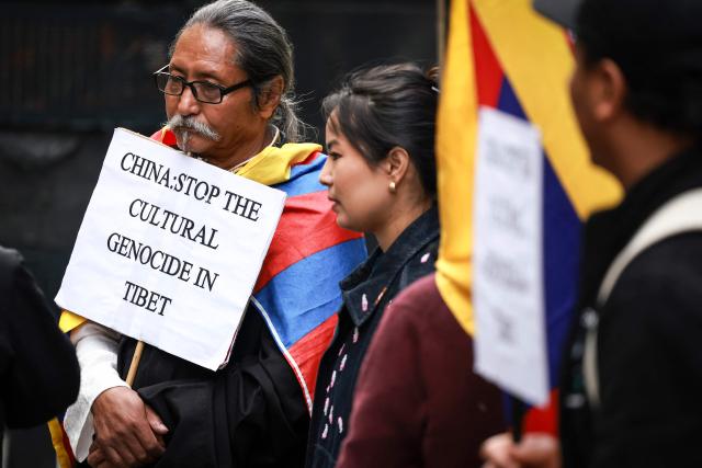 Members of the Australian Tibetan community react as they hold placards and flags during a protest in Sydney on July 1, 2026. (Photo by DAVID GRAY / AFP)