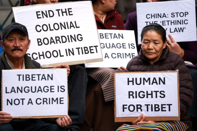 Members of the Australian Tibetan community react as they hold placards during a protest in Sydney on July 1, 2026. (Photo by DAVID GRAY / AFP)