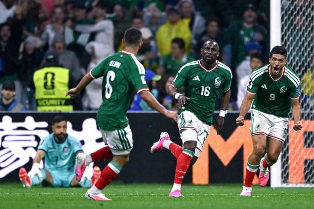 Mexico's forward #16 Julian Quinones celebrates with teammates midfielder #06 Erik Lira and forward #09 Raul Jimenez scoring his team's first goal during the 2026 World Cup round of 32 football match between Mexico and Ecuador at the Mexico City Stadium in Mexico City on June 30, 2026.  (Photo by CARL DE SOUZA / AFP)