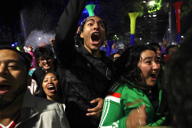 Mexican fans react as they watch the FIFA World Cup round of 32 football match between Mexico and Ecuado at the Angel of Independence in Mexico City on June 30, 2026. (Photo by Claudia Rosel / AFP)