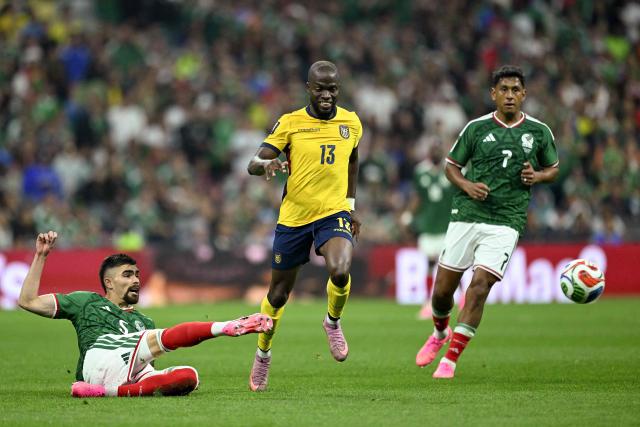 Mexico's defender #05 Johan Vasquez and Ecuador's forward #13 Enner Valencia fight for the ball next to Mexico's midfielder #07 Luis Romo during the 2026 World Cup round of 32 football match between Mexico and Ecuador at the Mexico City Stadium in Mexico City on June 30, 2026.  (Photo by CARL DE SOUZA / AFP)
