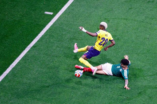 Ecuador's forward #20 Nilson Angulo and Mexico's defender #02 Jorge Sanchez fight for the ball during the 2026 World Cup round of 32 football match between Mexico and Ecuador at the Mexico City Stadium in Mexico City on June 30, 2026.  (Photo by Rodrigo Oropeza / AFP)