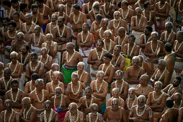 A group of priests take part by chanting mantras in a chariot festival of Sri Parthasarthy temple in Chennai on July 1, 2026. (Photo by R. Satish BABU / AFP)