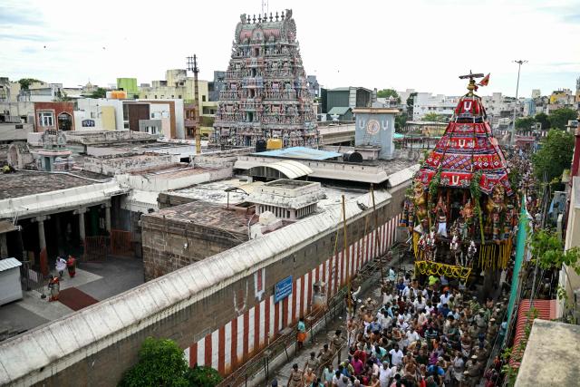 Devotees take part in a chariot festival of Sri Parthasarthy Temple in Chennai on July 1, 2026. (Photo by R. Satish BABU / AFP)
