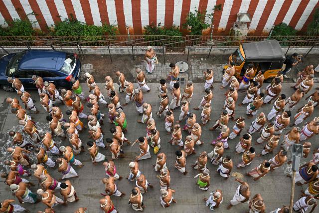 A group of priests take part by chanting mantras in a chariot festival of Sri Parthasarthy Temple in Chennai on July 1, 2026. (Photo by R. Satish BABU / AFP)