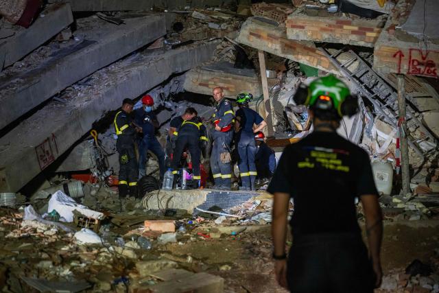 Members of the French 7th Civil Security Training and Intervention Regiment (RIISC 7) work during a rescue operation in Caraballeda, La Guaira state, Venezuela, on June 30, 2026. Tens of thousands of people urgently need food and shelter in Venezuela due to the devastation from two huge earthquakes that killed more than 1,700 and injured 5,000, the UN said on June 30, 2026, as doctors warned of potential outbreaks of disease. (Photo by Miguel MEDINA / AFP)