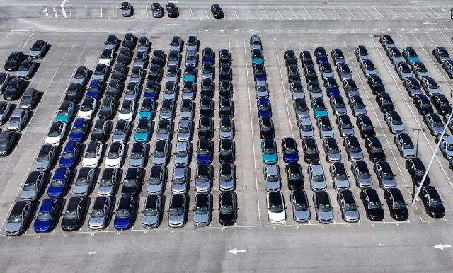 (FILES) An aerial view shows cars parked at the Stellantis automotive manufacturer plant in Poissy, west of Paris, on April 22, 2026. New car sales jumped 11.4% year-on-year in June, in a market that still has not returned to its pre-Covid-19 pandemic level, according to preliminary data released  on July 1, 2026 by the Automotive Platform (PFA). (Photo by Benoît DUCROCQ / AFP)