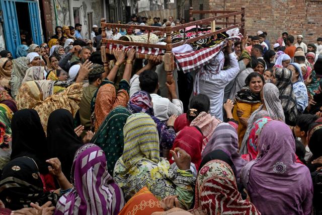 Relatives and local residents carry the bodies of deceased children for their funeral in Lahore on July 1, 2026, after the roof of a tutoring centre collapsed the previous day. A roof collapse at a tutoring centre in the eastern Pakistani city of Lahore killed at least 14 children and injured five on June 30, officials said. (Photo by Arif ALI / AFP)