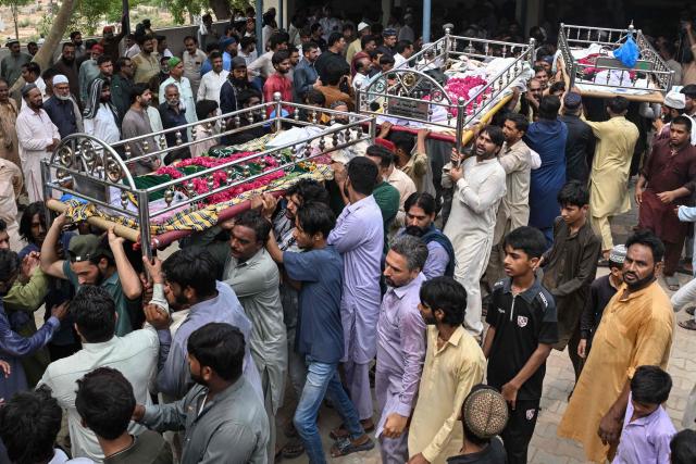 Relatives and local residents carry the bodies of deceased children for their funeral in Lahore on July 1, 2026, after the roof of a tutoring centre collapsed the previous day. A roof collapse at a tutoring centre in the eastern Pakistani city of Lahore killed at least 14 children and injured five on June 30, officials said. (Photo by Arif ALI / AFP)