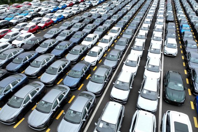 BYD and MG cars, from Chinese automakers, are seen at the Dongfang port branch of Lianyungang Port in Jiangsu province, eastern China on July 1, 2026, ready to be loaded onto ships for export. (Photo by -STR / CN-STR / AFP) / China OUT