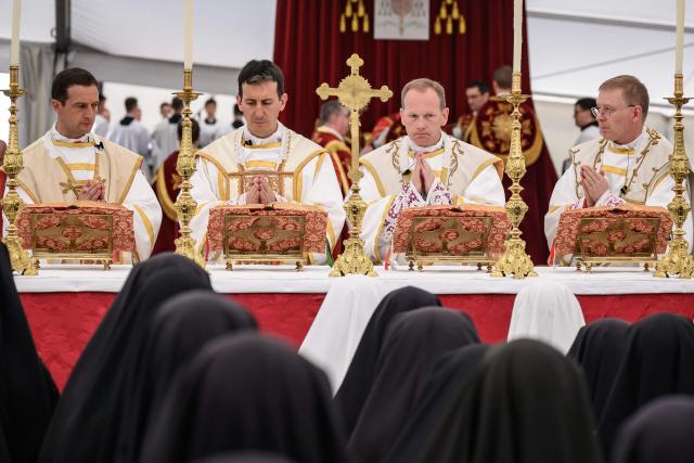 (From L) The new traditionalist Catholic bishops French Marc Hanappier, French Michel Poinsinet de Sivry, US' Michael Goldade and Swiss Pascal Schreiber stand during the schismatic consecration of bishops by the traditionalist Catholic Society of Saint Pius X (SSPX) in Econe, western Switzerland, on July 1, 2026. On June 30, 2026, Pope Leo XIV urged the Society to abandon its plan to ordain bishops without Vatican approval, warning it would lead to automatic excommunication. Founded in 1970 in Econe by French bishop Marcel Lefebvre, the Society of Saint Pius X categorically rejects the changes in the Church since the Second Vatican Council. (Photo by Fabrice COFFRINI / AFP)