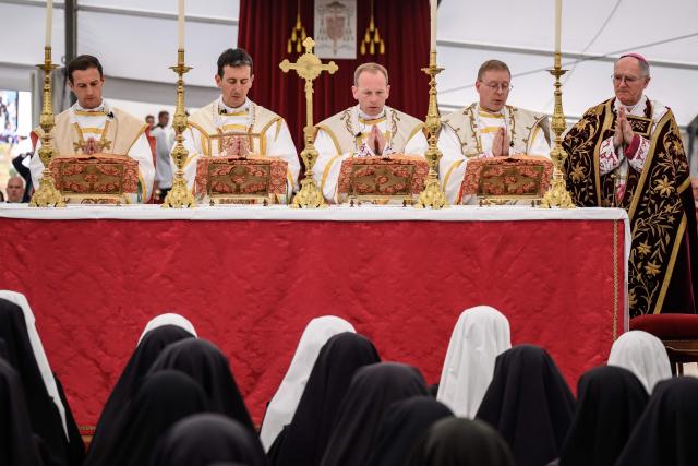 (From L) The new traditionalist Catholic bishops French Marc Hanappier, French Michel Poinsinet de Sivry, US' Michael Goldade and Swiss Pascal Schreiber stand next to Swiss traditionalist Catholic Bishop of the Society of Saint Pius X (SSPX) Bernard Fellay during the schismatic consecration of bishops by the traditionalist Catholic Society of Saint Pius X (SSPX) in Econe, western Switzerland, on July 1, 2026. On June 30, 2026, Pope Leo XIV urged the Society to abandon its plan to ordain bishops without Vatican approval, warning it would lead to automatic excommunication. Founded in 1970 in Econe by French bishop Marcel Lefebvre, the Society of Saint Pius X categorically rejects the changes in the Church since the Second Vatican Council. (Photo by Fabrice COFFRINI / AFP)